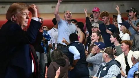Mitingde Trump'ı protesto edenler yaka paça salondan atıldı